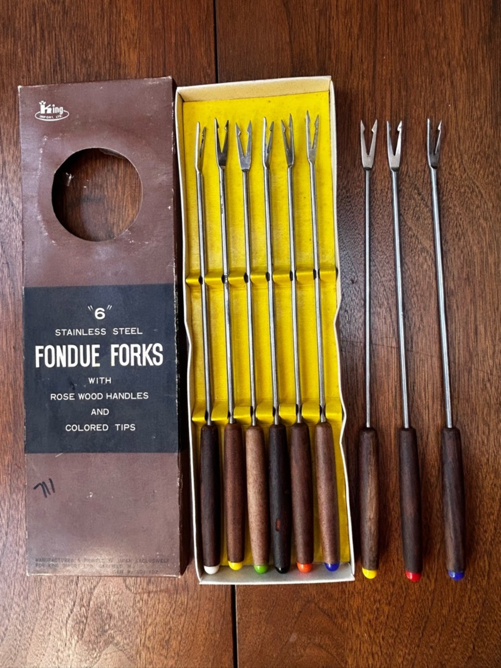 Nine vintage 1960s rosewood handled fondue forks with colored tips, by King.